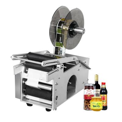 China MT-50 manual food price round bottle labeling machine cheap handheld semi-automatic press label machine hand model for food for sale