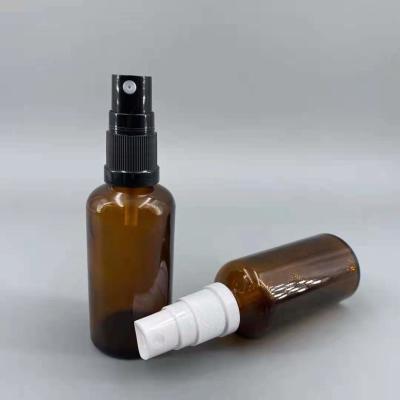 China 1 oz fine mist glass spray bottle 2 oz amber glass boston round bottles black treatment pump for sale