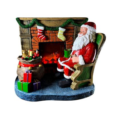 China Christmas Decoration COPYRIGHT Christmas Decoration With Santa Claus Sits By Electric Chimneys Inserted for sale