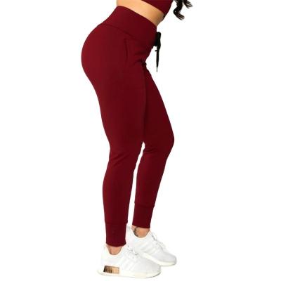 China Breathable Solid Seamless High Waisted Pocket Comfortable Low Price Yoga Gaiters Pants For Women for sale