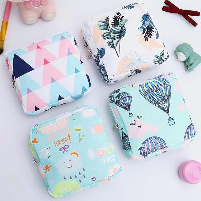 China 2021 Wholesale Low MOQ Cute Printed Cotton Filter Frames Sanitary Napkin Storage Bag Travel Zipper Lock Cosmetic Packaging Bag For Women for sale