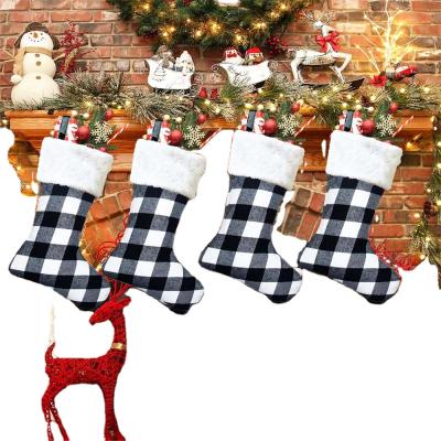 China Wholesale Custom Red And Black Non Woven Fabric Christmas Plaid Plush Cuffs Candy Gift Bag for sale