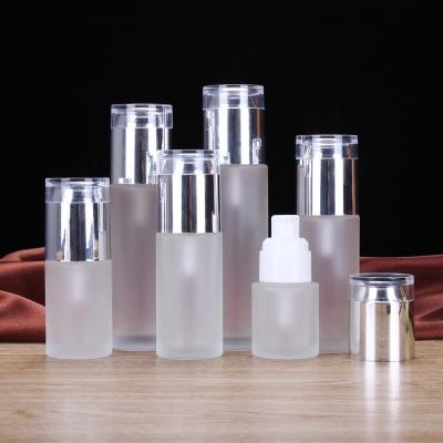 China Personal Care Frosted Clear Glass Cosmetics Containers 50ml 80ml 100ml 120ml Packaging Lotion Glass Bottles With Silver Pump for sale