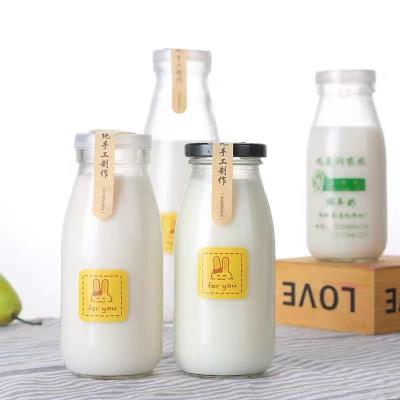 China Beverage 500ml 1000ml 1 Liter Clear Empty Glass Round Milk Bottles With Metal Lids Glass Beverage Bottles for sale