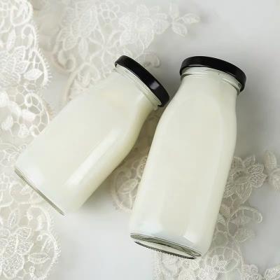 China Beverage Wholesale 200ml 250ml 500ml Transparent Round Glass Milk Bottle Beverage Bottle with Tinplate Cap for sale