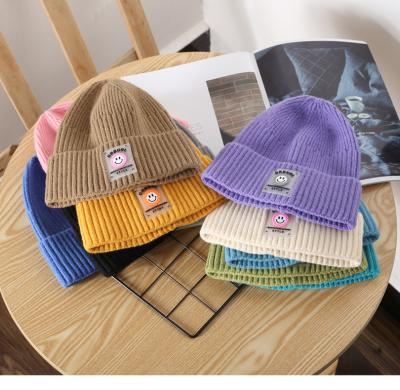 China COMMON 2021 New Coming 11 Colors Store Rubber Patch Beanie Hats Wholesale Smile Volume for sale