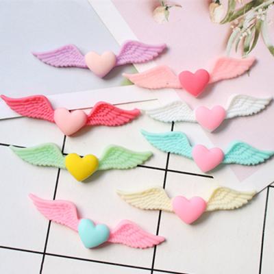 China Beautiful global flatback colorful heart wings design resin cabochons phone case mobile cover accessories diy decoration for sale