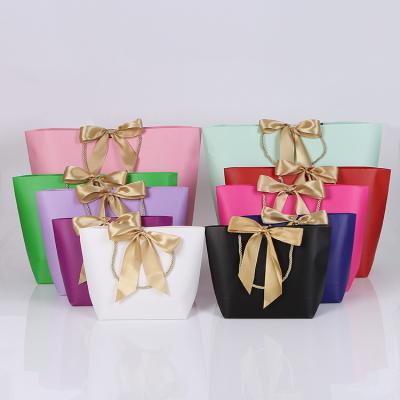 China Recyclable Custom Logo Gold Paper Bag Present Wedding Wrapping Paper Gift Bags Garment Package Bag for sale