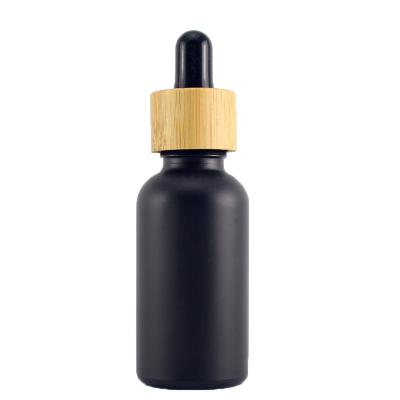 China Refillable Essential Oil Bamboo Bottle Cap 30ml Matte Black Bamboo Bottle Frosted Black Lid for sale