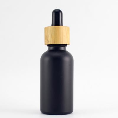 China Cosmetic massage oil dropper glass bottle with bamboo dropper cap for essential oil olive oil for sale