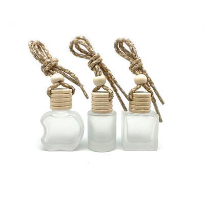 China Cosmetic Empty Car Perfume Glass Hanging Freshener Diffuser Bottles Air With Wooden Cap Perfume Bottle for sale