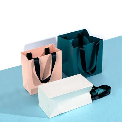 China Custom Retail Bulk Paper Bags Recyclable Design Cheap Shopping Pink Paper Packaging Gift Bag for sale