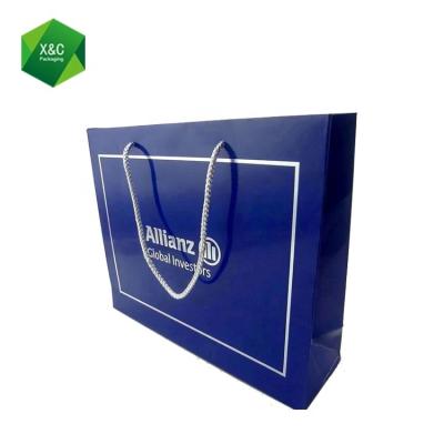 China Recyclable Custom Printed Luxury Blue Silver Foil Paper Gift Garment Shopping Bag With Handle for sale