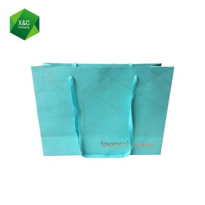 China Logo Print Blue Garments Packaging Disposable Custom Silver Paper Shopping Bag for sale