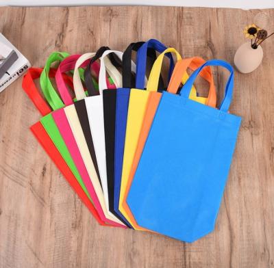 China Cheap Handled Logo Tote Stock Foldable Nonwoven Promotional Sack Bag Custom Shopping Bag For Advertising for sale