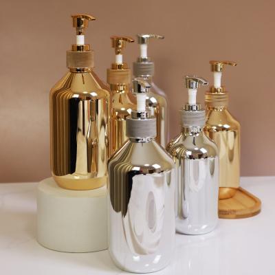 China Gold Bottle 100ml 200ml 300ml 400ml 500ml Cosmetic Gold Plated Bottle Cosmetics Plastic Bottle for sale