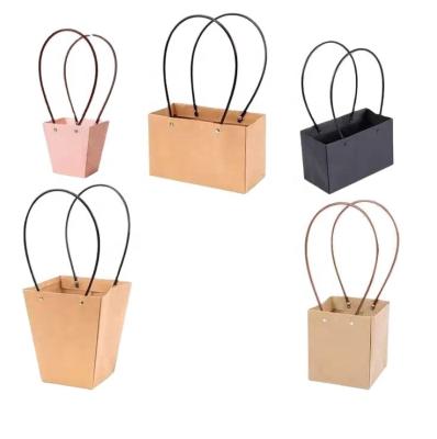 China Biodegradable Paper Flower Bag Waterproof Trapezium Flower Bag With Plastic Handle for sale