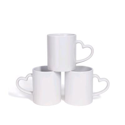 China Sublimation Blank White 11oz Coffee Mug Sustainable For Sublimation With Heart Handle for sale