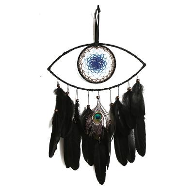 China Amazon hotsale country by country Eye of God wall decoration ornament handmade black feather wall hanging blue eye dreamcatcher for sale