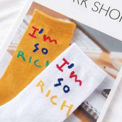 China Customized LOGO QUICK DRY knitted socks creative European and American street letter ISI mid length socks for sale