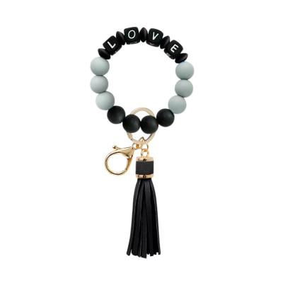 China Fashionable creative LOVE bracelet key chain silicone bead letter tassel bracelet key chain new for sale