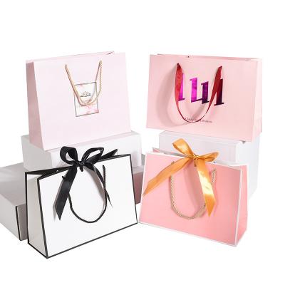 China Custom Printed Logo Luxury Clothing Packaging Paper Bags for Boutique Gift US Currency for sale