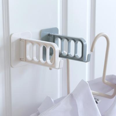 China Modern Hanger Storage Organizer Balcony Drying Rack Hook Wardrobe Hanger Foldable Punch Free Container for sale