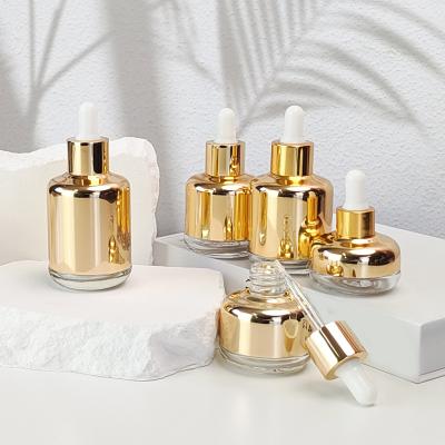 China Wholesale 20ml 35ml 50ml 55ml 70ml Essence Glass Dropper Bottle Gold Plated Cosmetic Luxury Essential Oil New Design for sale