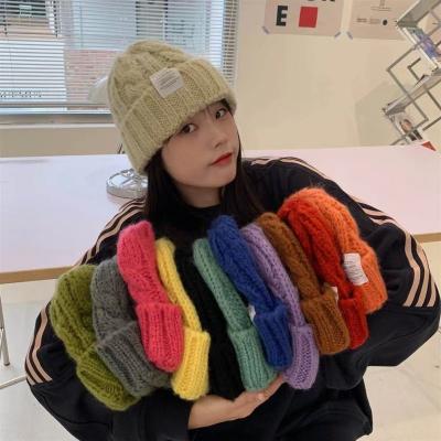 China COMMON Wholesale Winter Knit Beanies Solid Color Wool Winter Cap Female Warm Fisherman Hat Blend for sale