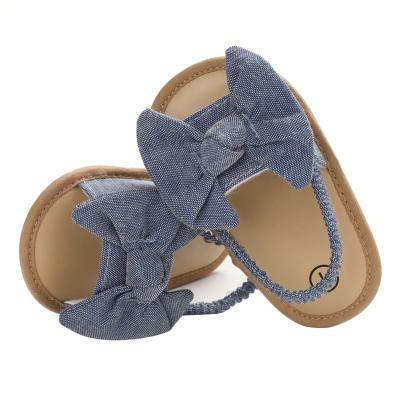 China Summer men and women universal baby bow decoration flat wholesale soft bottom non-slip outdoor sandals for sale