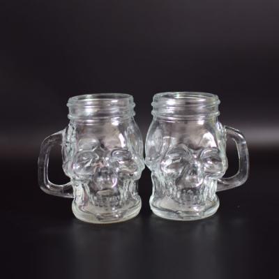 China Viable Wholesale Glass Jar With Handle 100ml Skull Shaped Glass Mason Jar for sale