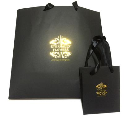 China Custom Logo Black Gold Matt Kraft Paper Bag With Hot Foiled Stamping Cotton Rope Handles Recyclable for sale