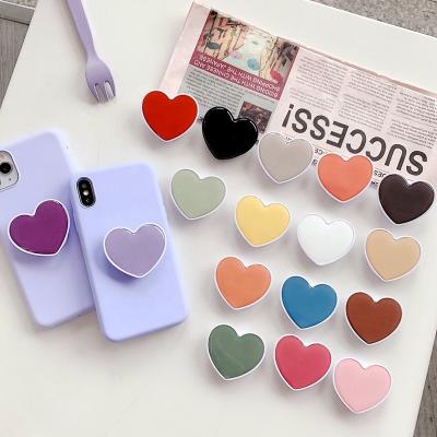 China Custom Phone Sockets New Solid Color Epoxy Resin Phone Holder Adjustable Handle Heart Shaped Mobile Promotional Gifts With Logo for sale