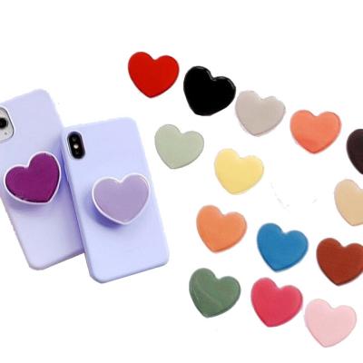 China Custom Phone Sockets New Solid Color Epoxy Resin Phone Holder Adjustable Handle Heart Shaped Mobile Promotional Gifts With Logo for sale