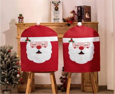 China Nonwoven Textiles Wholesale Classic Red Santa Hat Chair Cover Christmas Decoration for sale