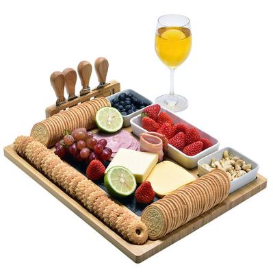 China Sustainable Wholesale Wooden Slate Cheese Board Slate Black Bamboo Charcuterie Board With Rack Up Knife Set for sale