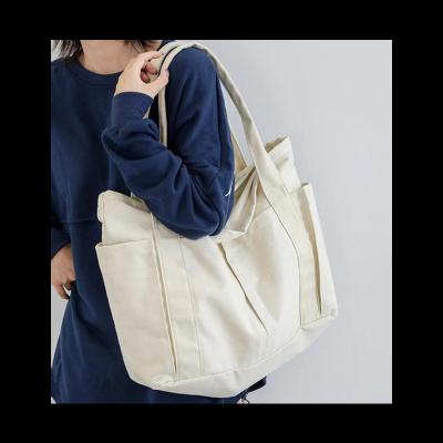 China Eco-friendly Reusable Customized Plain Multi-functional Wide Strap Compartments Shoulder Bag Tote Shopping Bag Student Women Canvas Handbag for sale