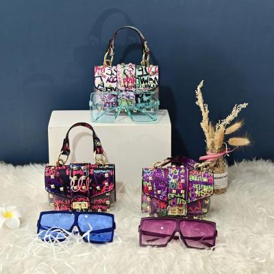 China Fashion Rivets Young Lady Purses Handbag Cover Transparent PVC Women Shoulder Handbags And Matching Sunglasses for sale