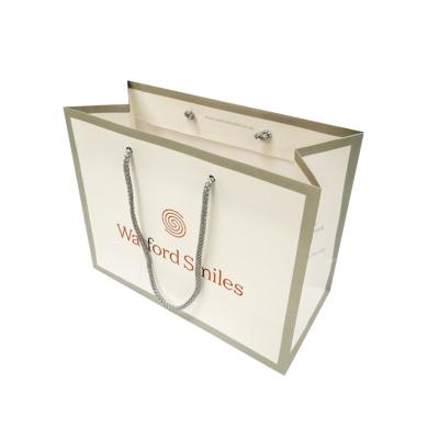 China Recyclable Luxury Ribbon Handle Boutique Shopping Packaging Customized Euro Printed Paper Gift Bag for sale