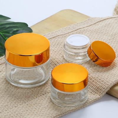 China Personal Care Round Glass Bottle Cosmetic Jar With 30g Glass Jar Black / Gold Screw Cap for sale