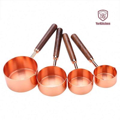 China Sustainable Set of 4 Rose Gold Wooden Handle Measuring Spoons Copper Set for sale