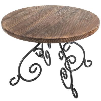 China Europe Wooden Dessert Cake Stand Shelf Riser With Scrollwork Design Black Metal Pedestal Base Rustic Burnt Round Wooden Cake Stand for sale