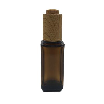 China Personal Care Bamboo Drop Press Amber PETG Cap 10ml Oil Bottles With Dropper for sale