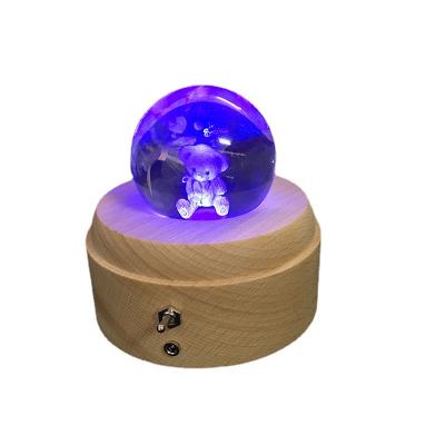 China Modern Creative Gifts Beech Rotary Music Box Bottom Cartoon Patterned Crystal Ball Music Box Decoration for sale