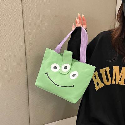 China 2023 Japanese Simple Fresh Green Cartoon Canvas Soft Portable Bag for sale