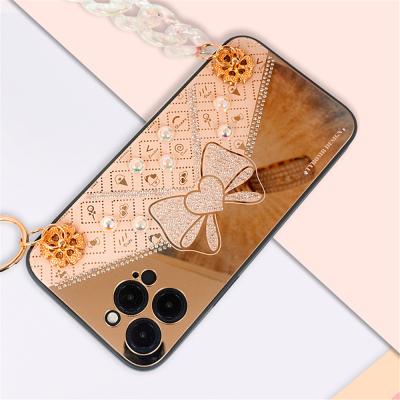 China Hot Sale Anti-fall Luxury Glitter Bling Bling Phone Case with Rhinestone Butterfly Bowknot Pearl String Strap for iPhone 11 12 13 pro max for sale