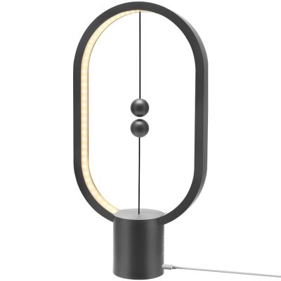 China JACKYLED USB Rechargeable Ellipse Modern Balance Touch Control LED Magnetic Switch Table Lamp for sale