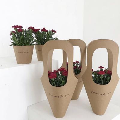 China Recycled Black Printed Brown Paper Florist Name Flower Bouquet Carrier Bag Packaging Materials for sale