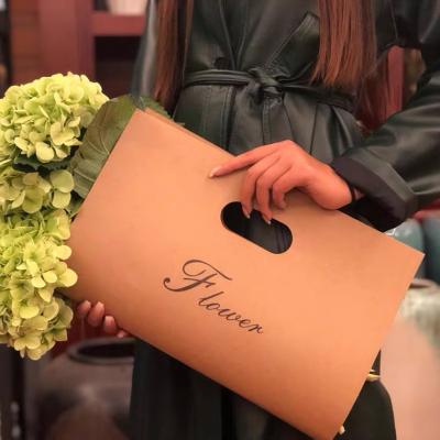 China Recycled Materials Luxury Take Away Flower Paper Bags Flower Carrier Sleeves For Boutique Bouquet Flower Carrier Bag for sale