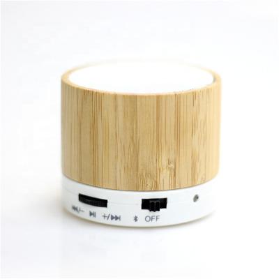 China Promotional wholesale gift a10 DTS mini mobile phone 3w wireless outdoor portable led light up bamboo speaker for sale